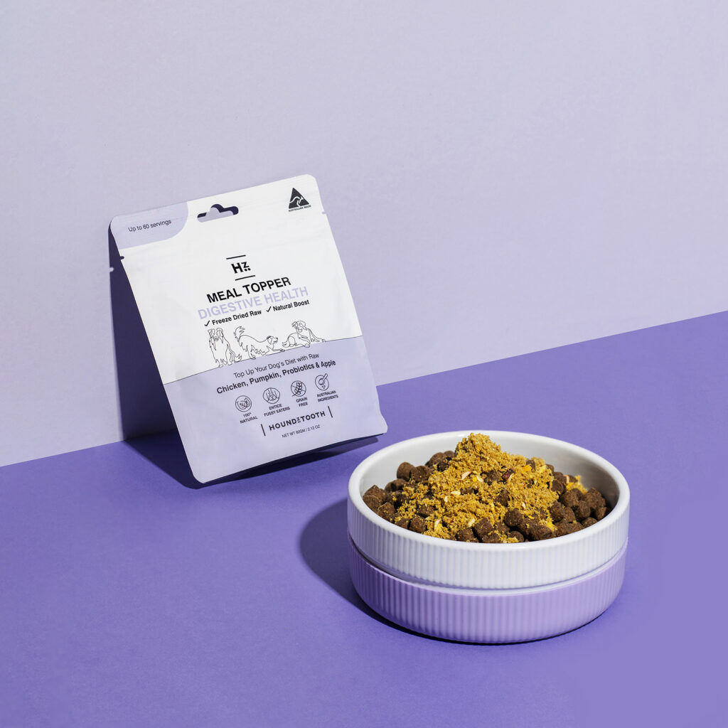 Dog digestive health meal topper sprinkled on dog food for gut support