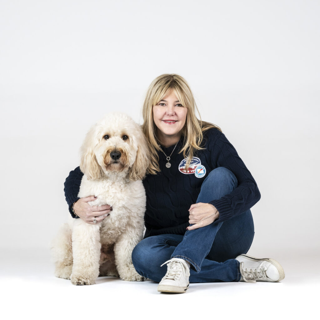 Rachael founder of Houndztooth hugging her dog Lenny showing the bond between pet and owner
